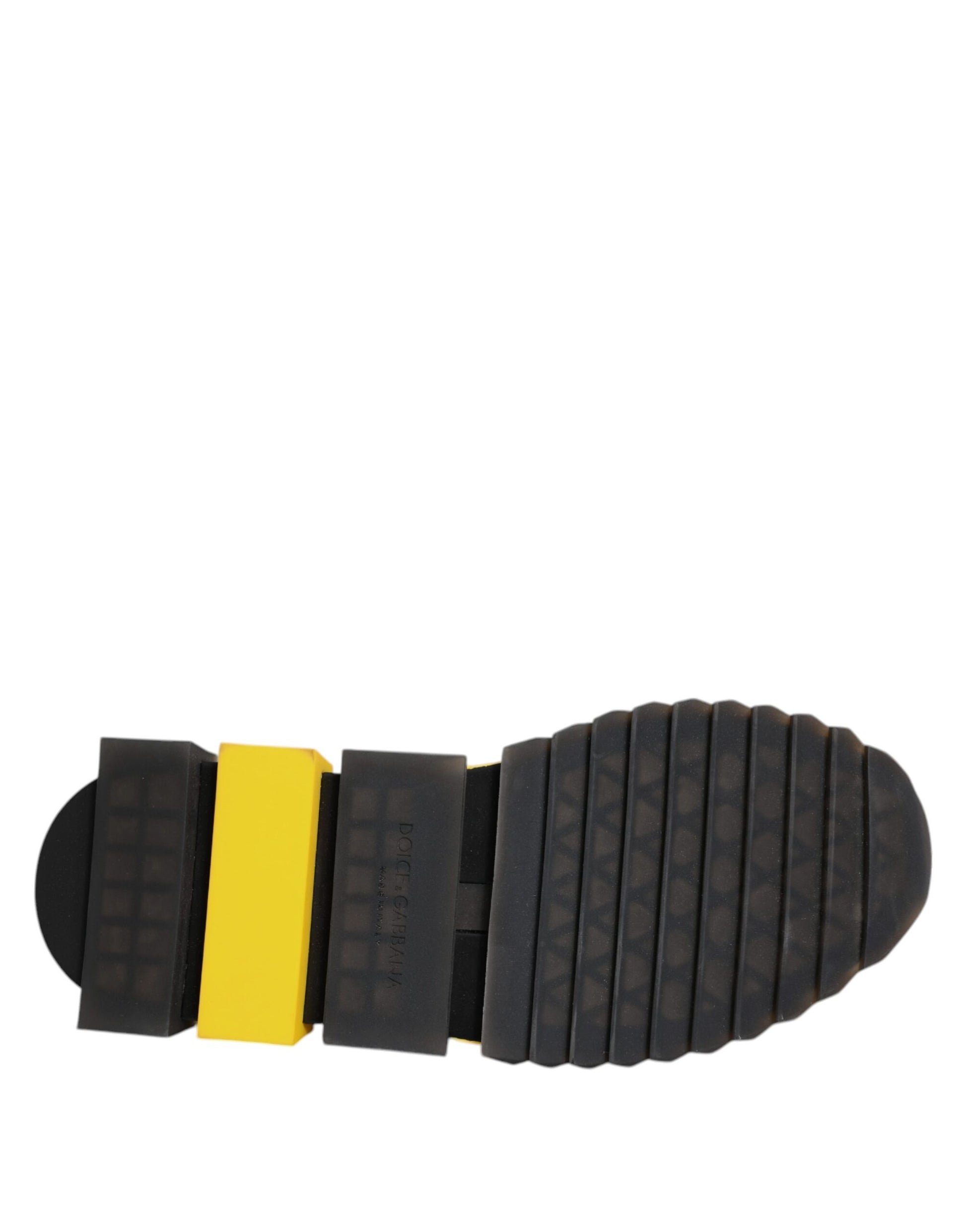 Yellow and black shoe sole with cleats