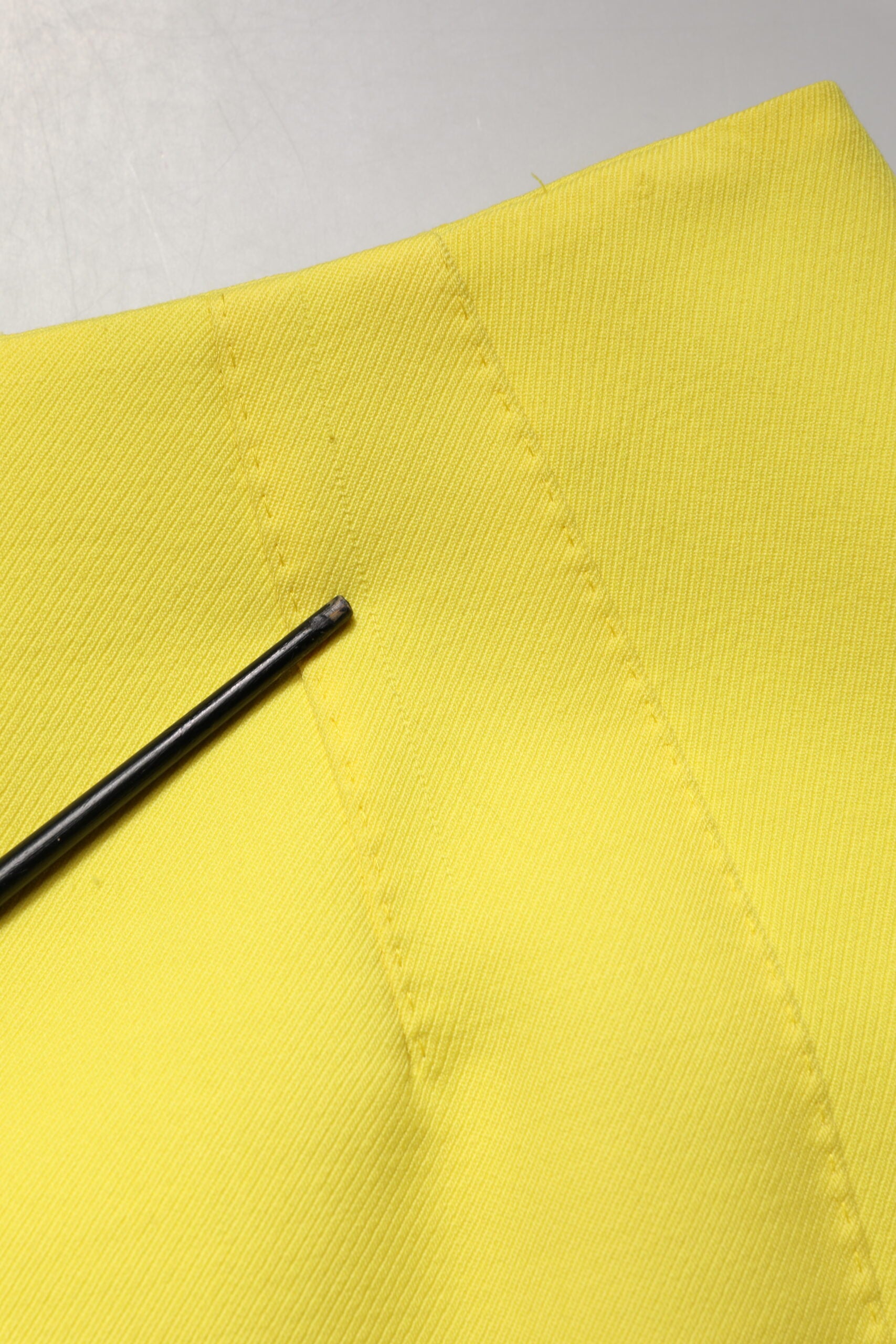 Yellow fabric with black pin