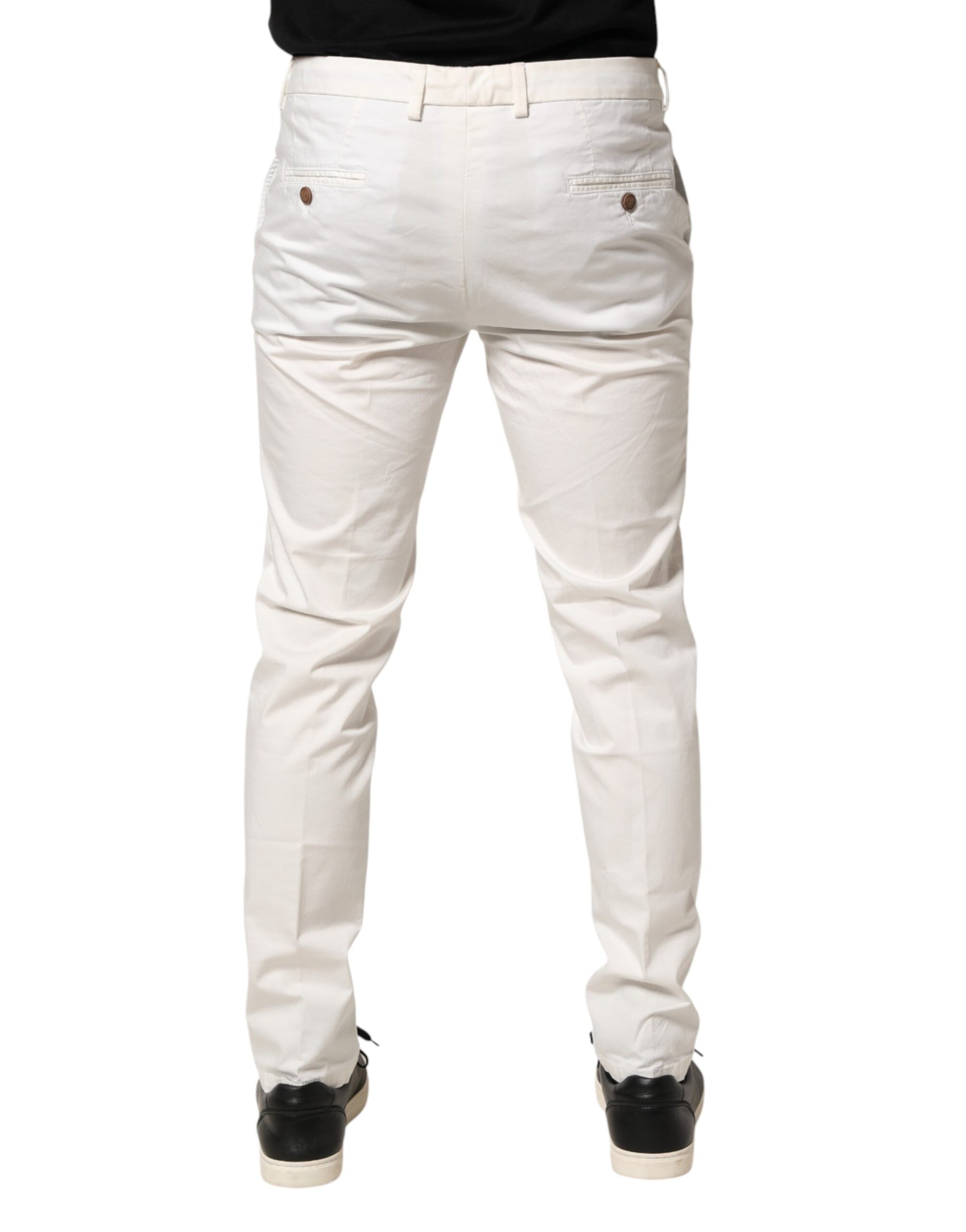 A pair of white tapered dress pants with a slim fit and visible stitching