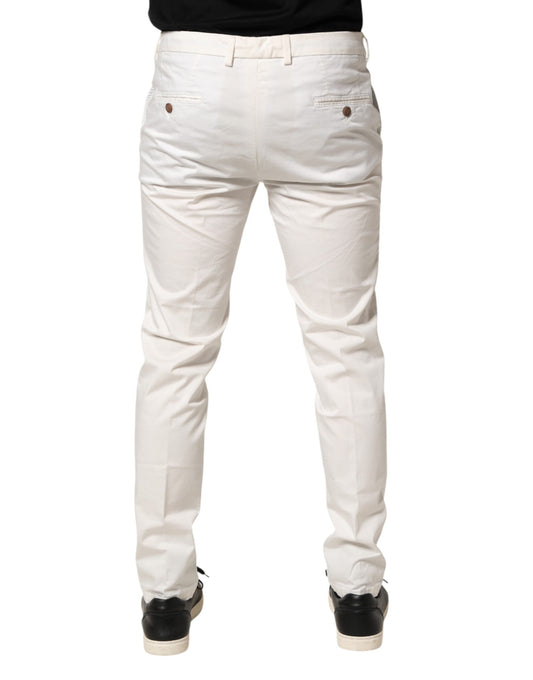 A pair of white tapered dress pants with a slim fit and visible stitching