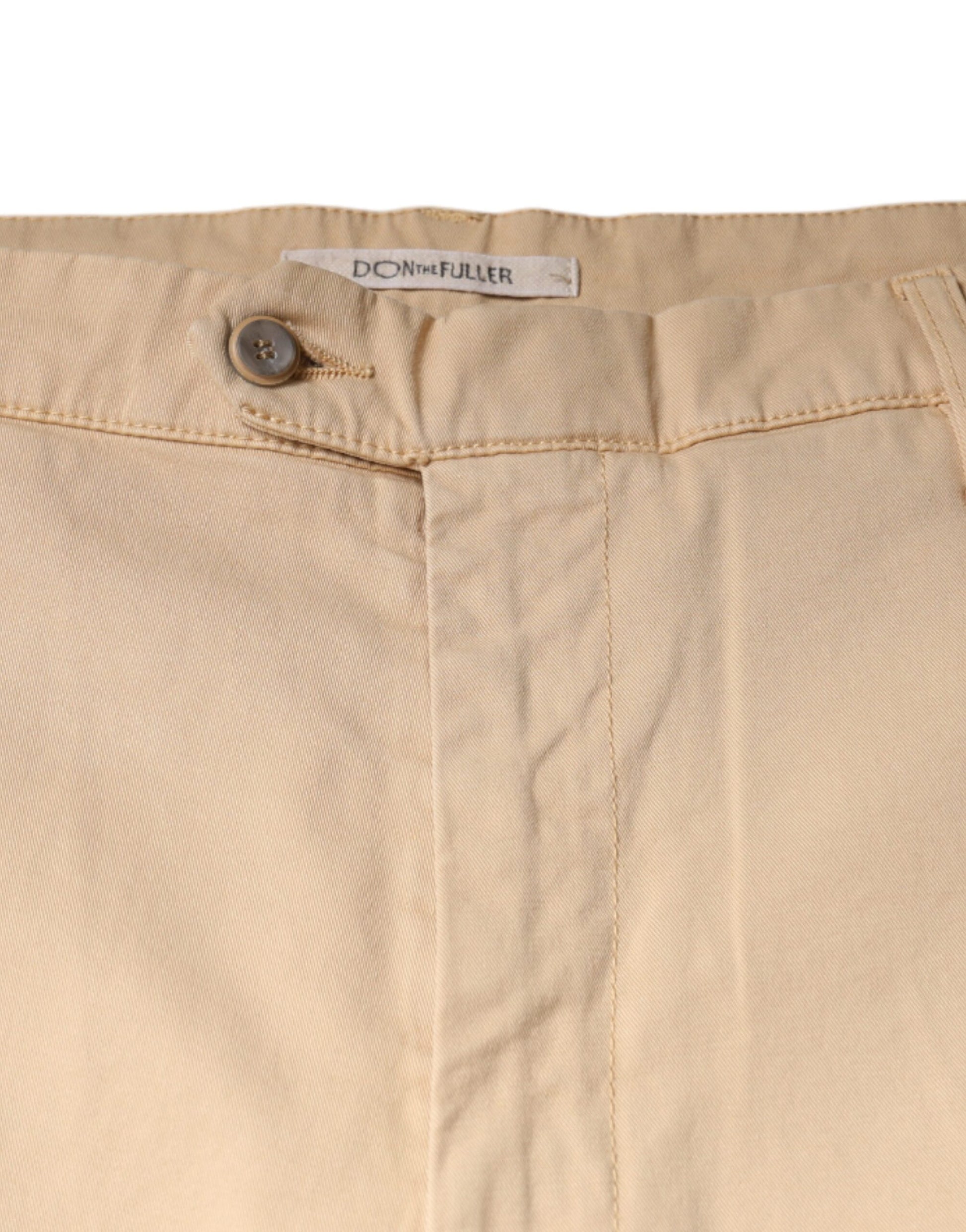 Tan cropped dress pants with button closure, side pockets and belt loops