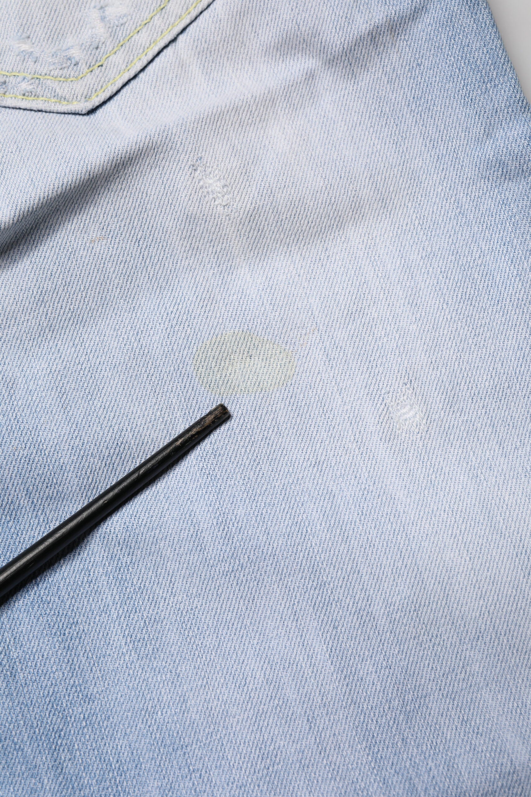 Blue denim jeans with a black marking pen on them