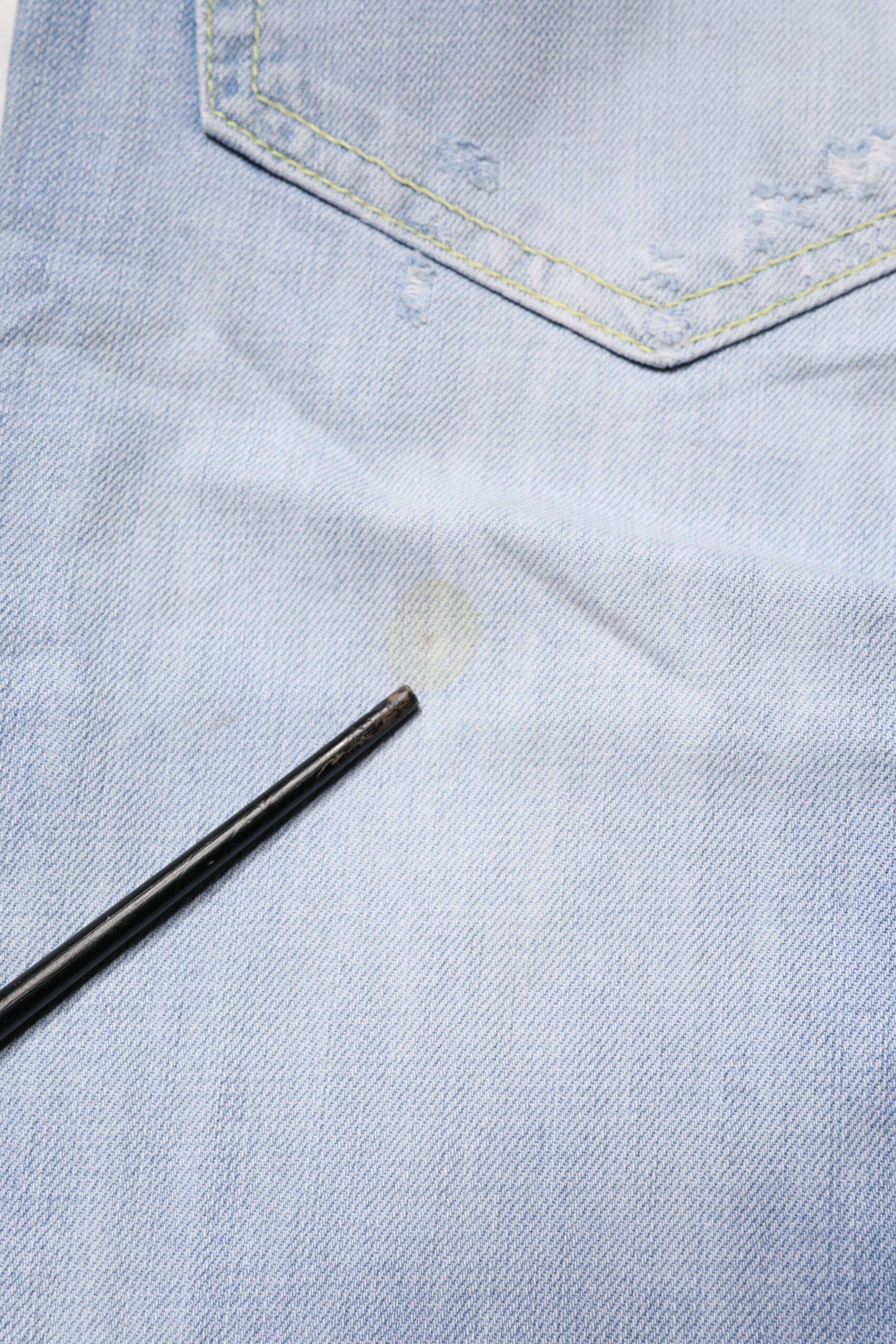 Blue denim jeans with a black pen mark on them