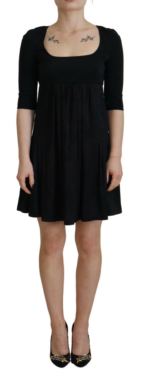 A black dress with short sleeves and an A-line skirt. It is made of acetate material, as indicated by the bra