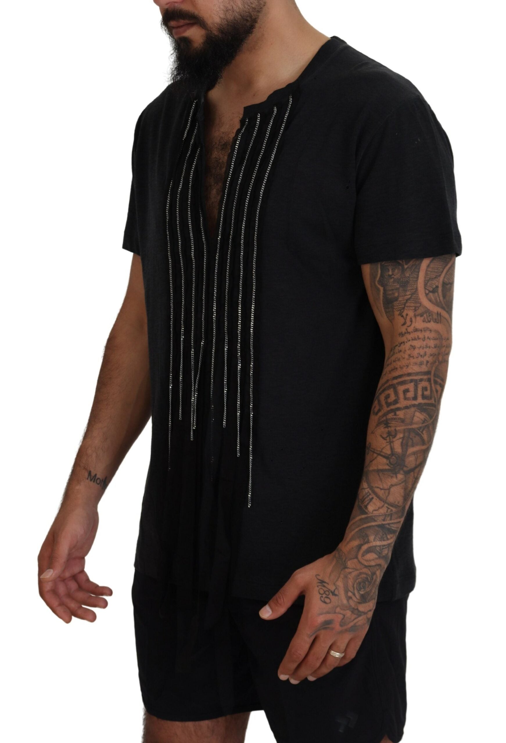 Man wearing black t-shirt with embroidered design on front