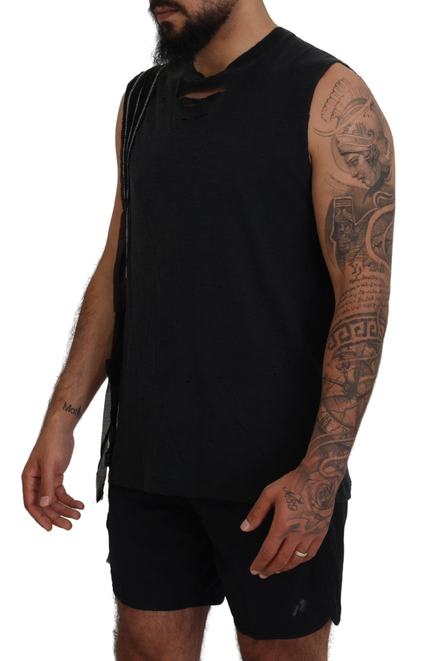 Man wearing black tank top with tattoos on arms