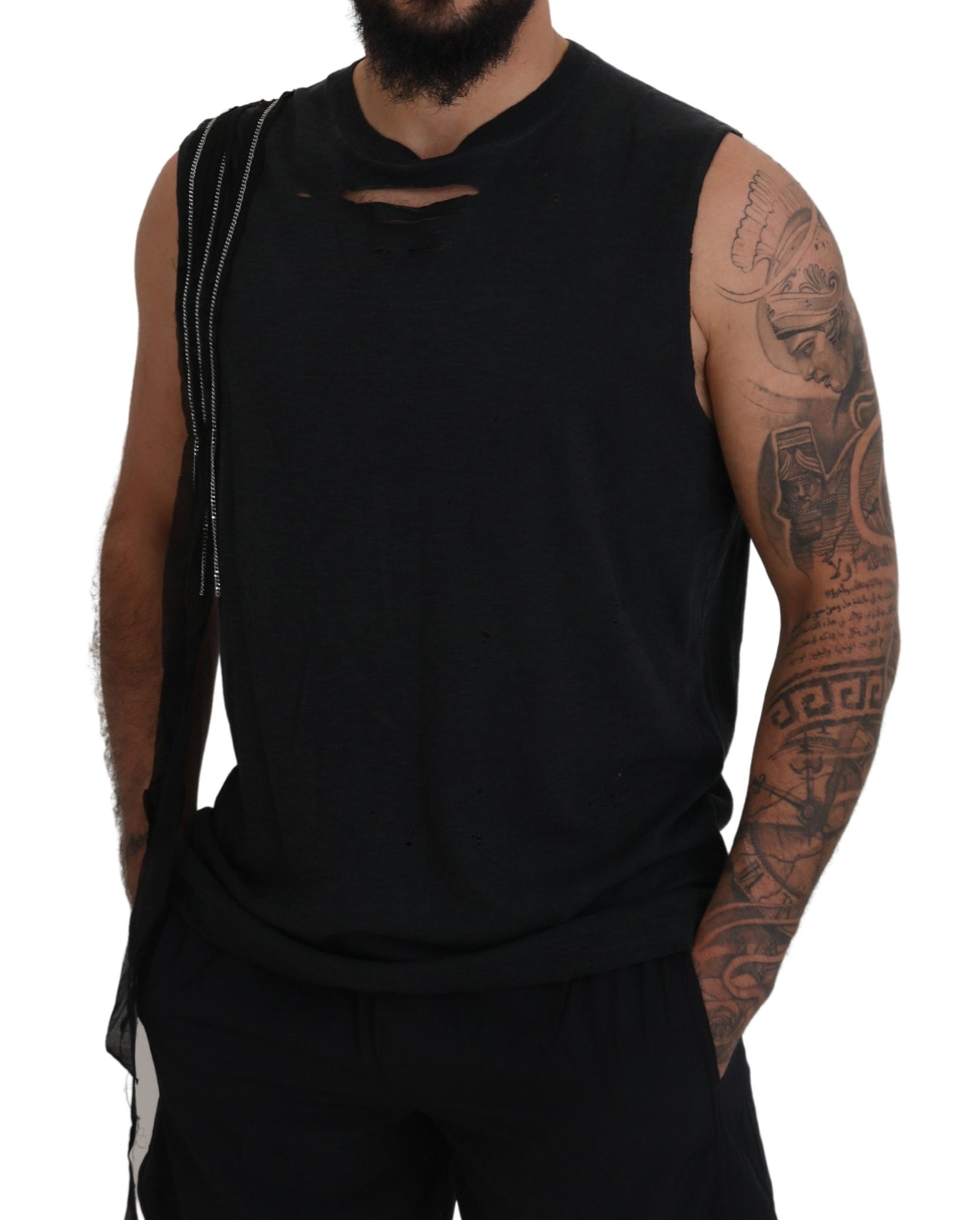 Man wearing black tank top with ripped sleeves and tattoos on arms