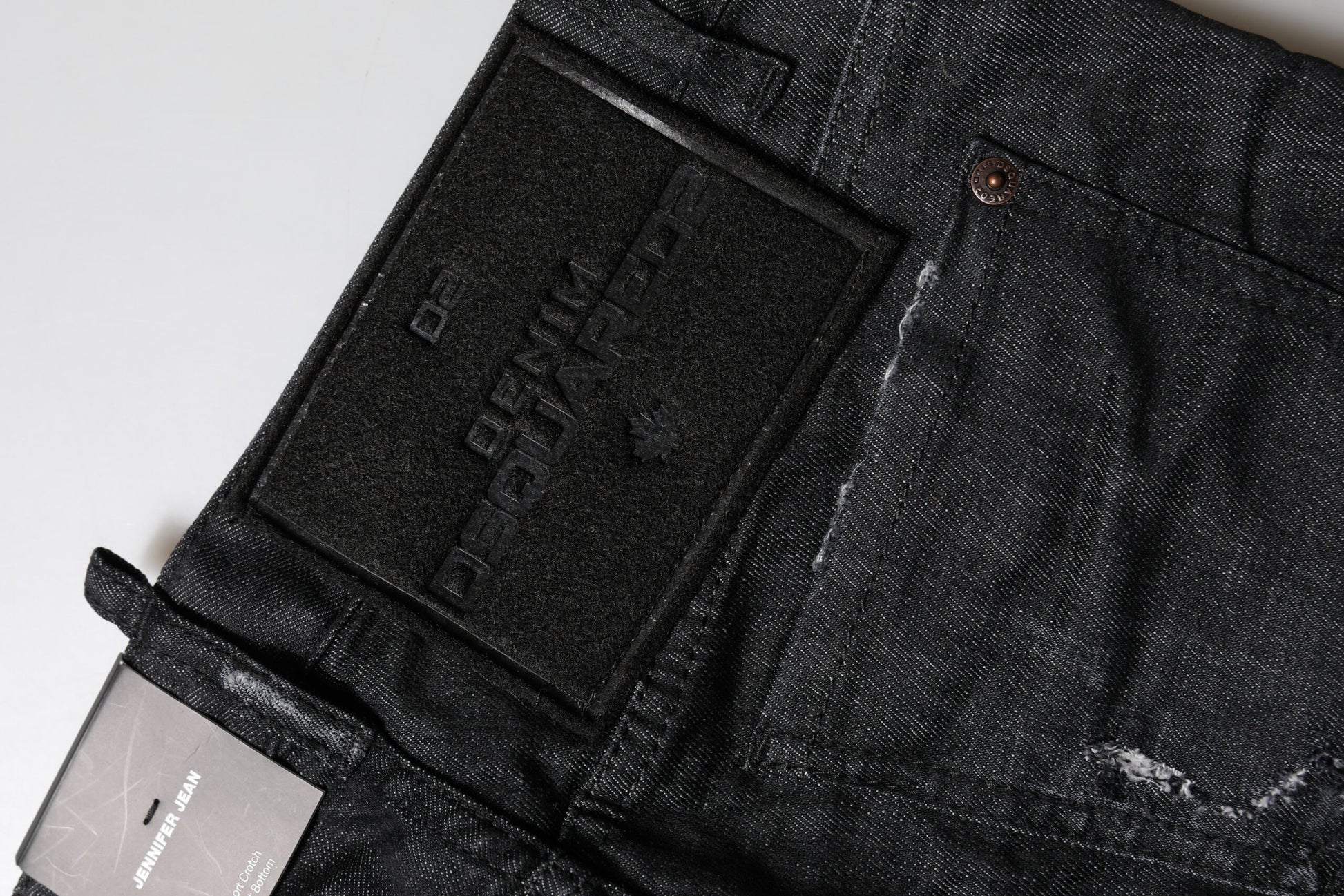 Pair of blue jeans with black label on back pocket
