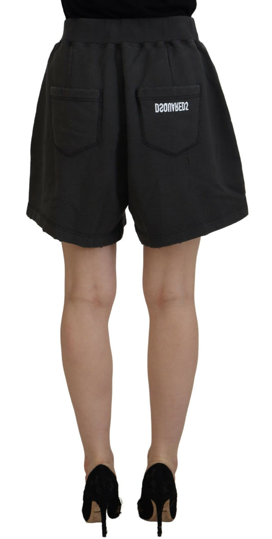 A pair of black cotton shorts with tapered legs and mid waist, featuring a distressed design
