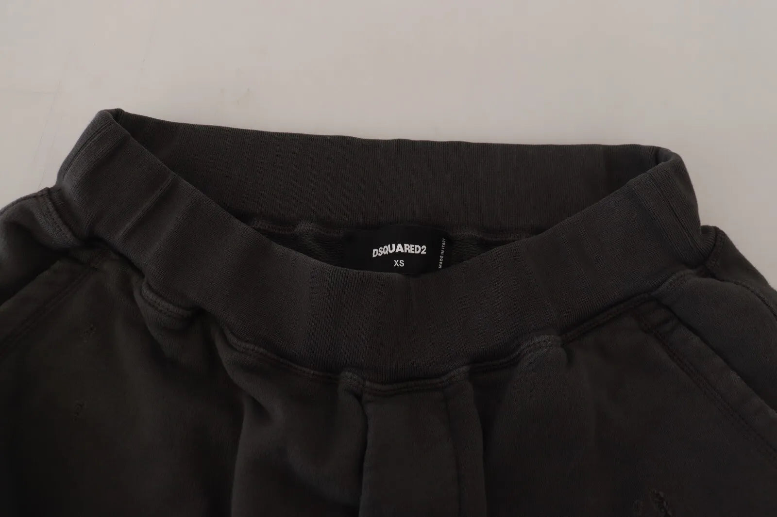A pair of black cotton shorts with a tattered design and mid-waist band