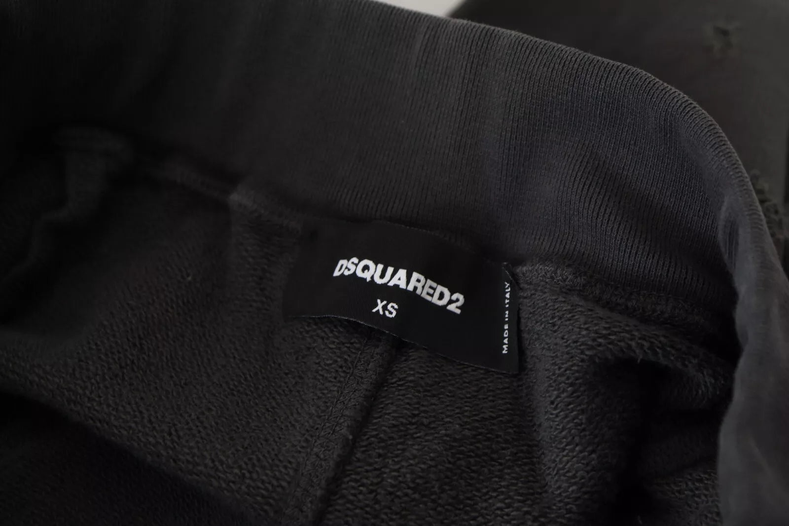 A pair of black cotton shorts with a tattered design and a mid waist