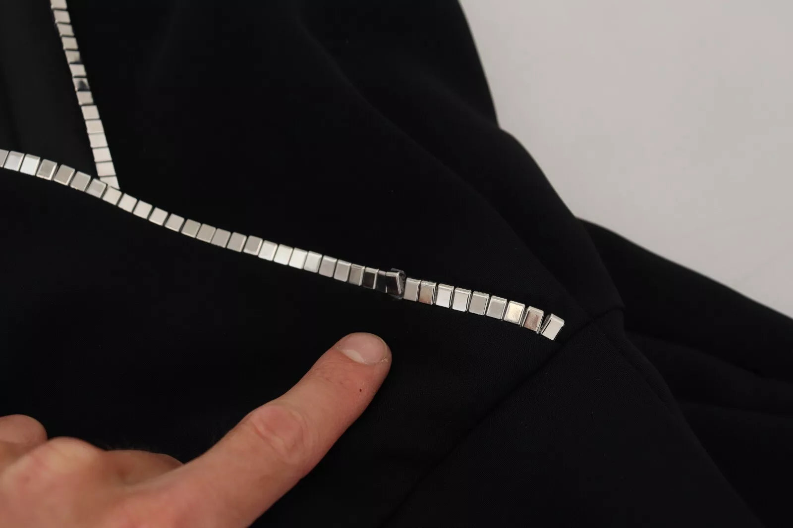 A black sleeveless jumpsuit dress with embellishments