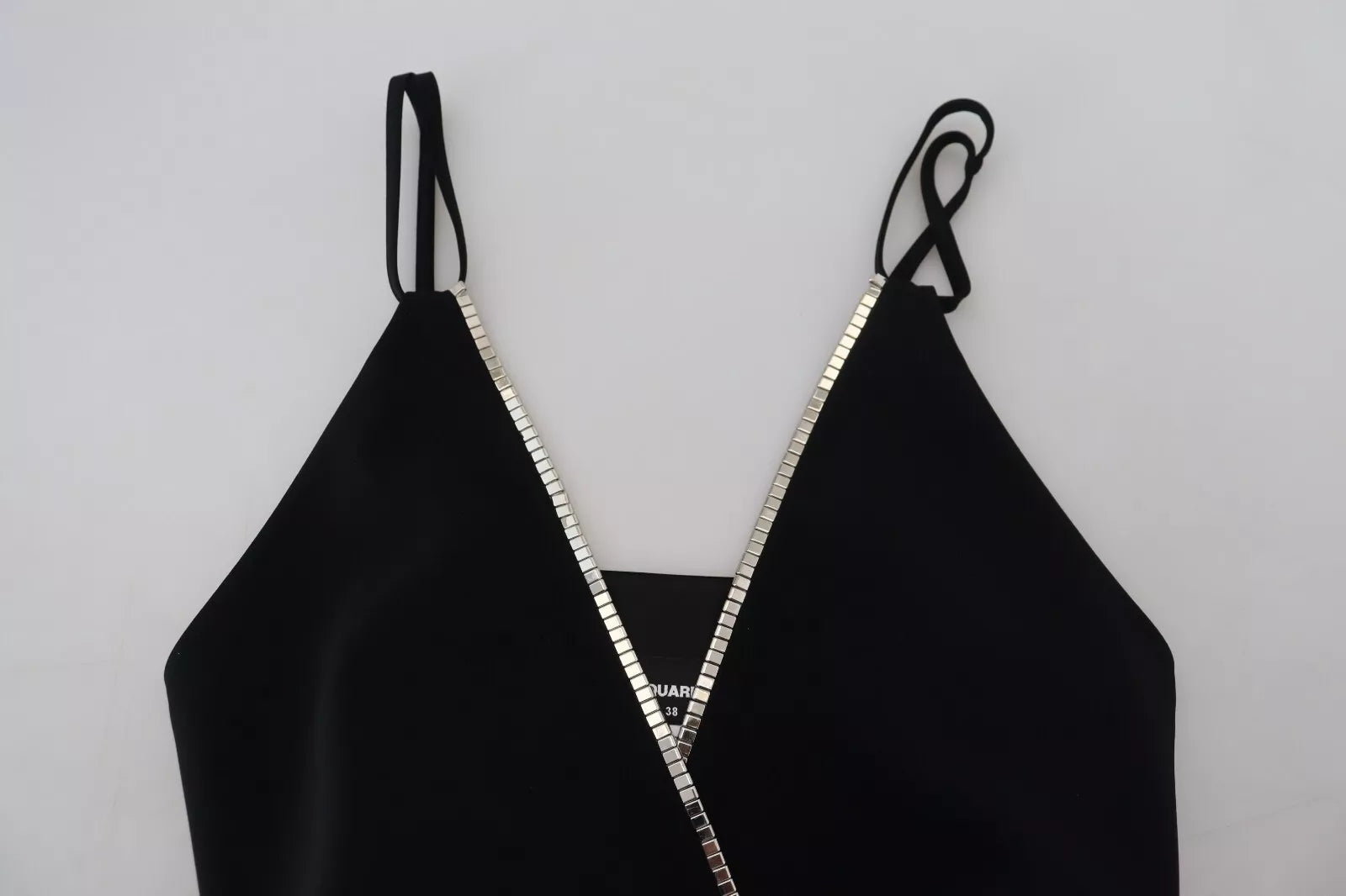 A black jumpsuit dress with embellishments and a V-neck