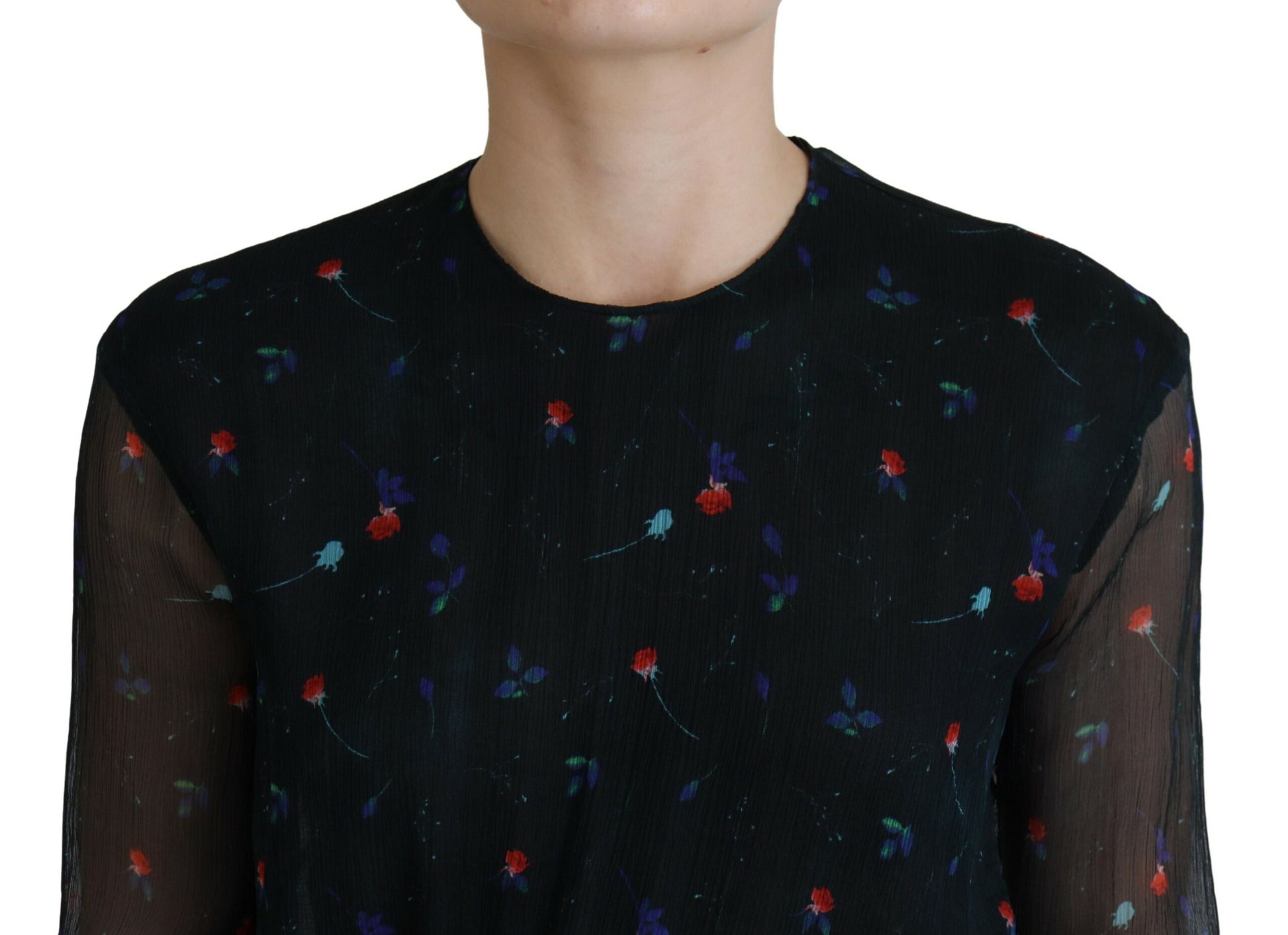 A black dress with floral pattern on silk fabric, featuring long sleeves and a sheath style