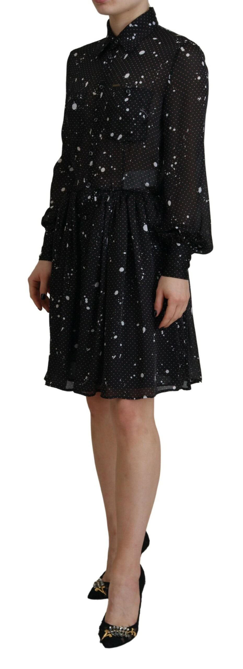 A black dress with polka dots, long sleeves and a button down front