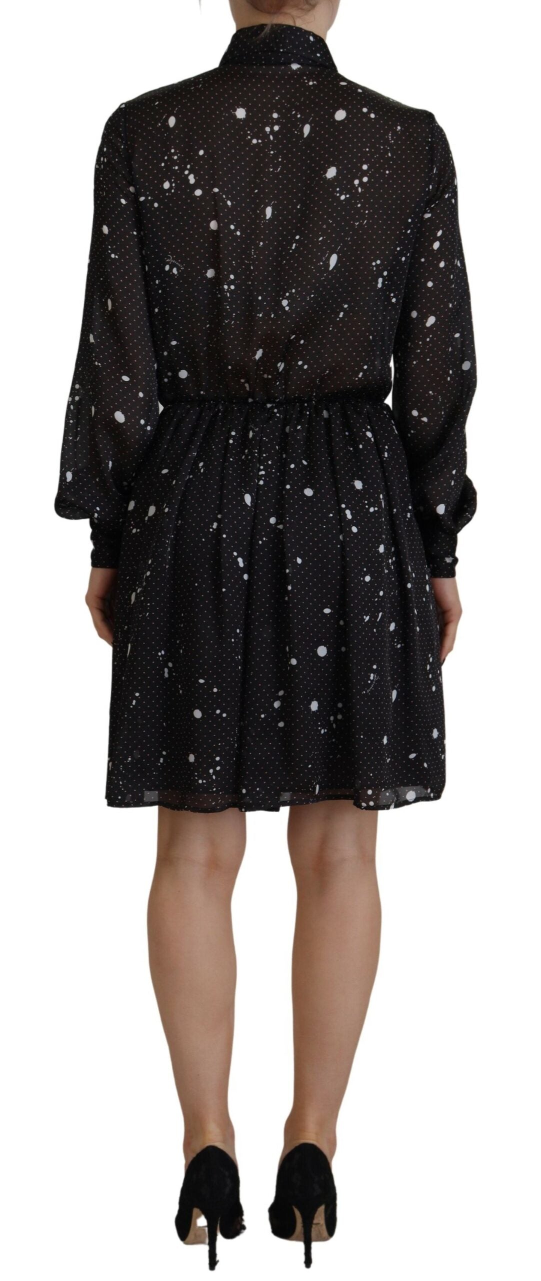 A black dress with polka dots on a white background