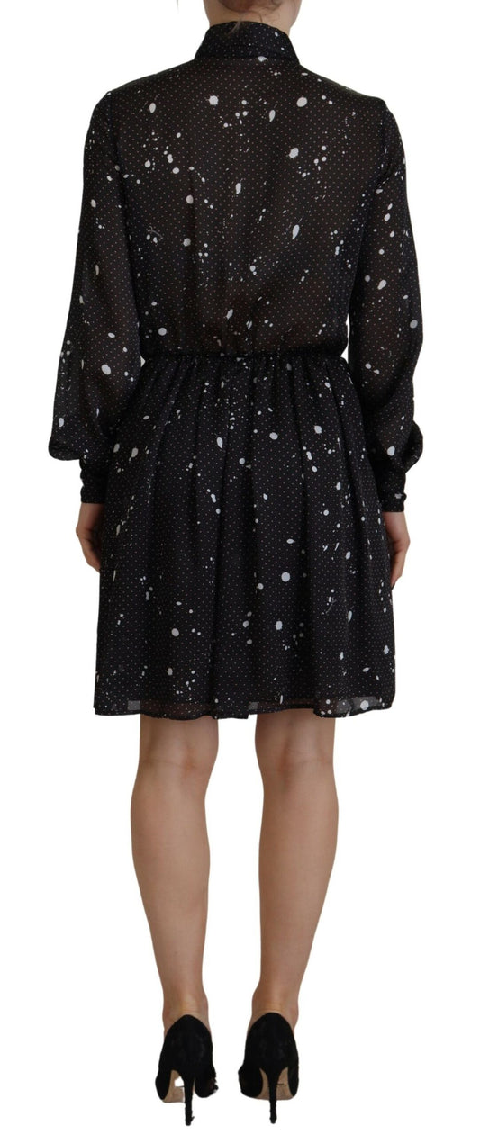 A black dress with polka dots on a white background