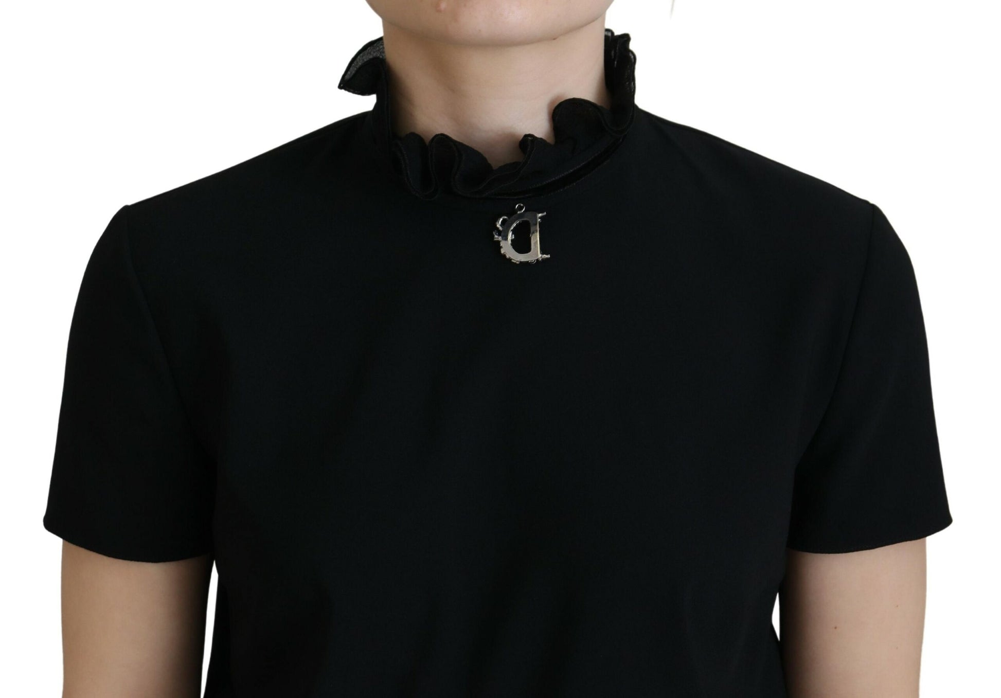 A black short sleeve sheath dress with a high neckline and a bow detail on the front