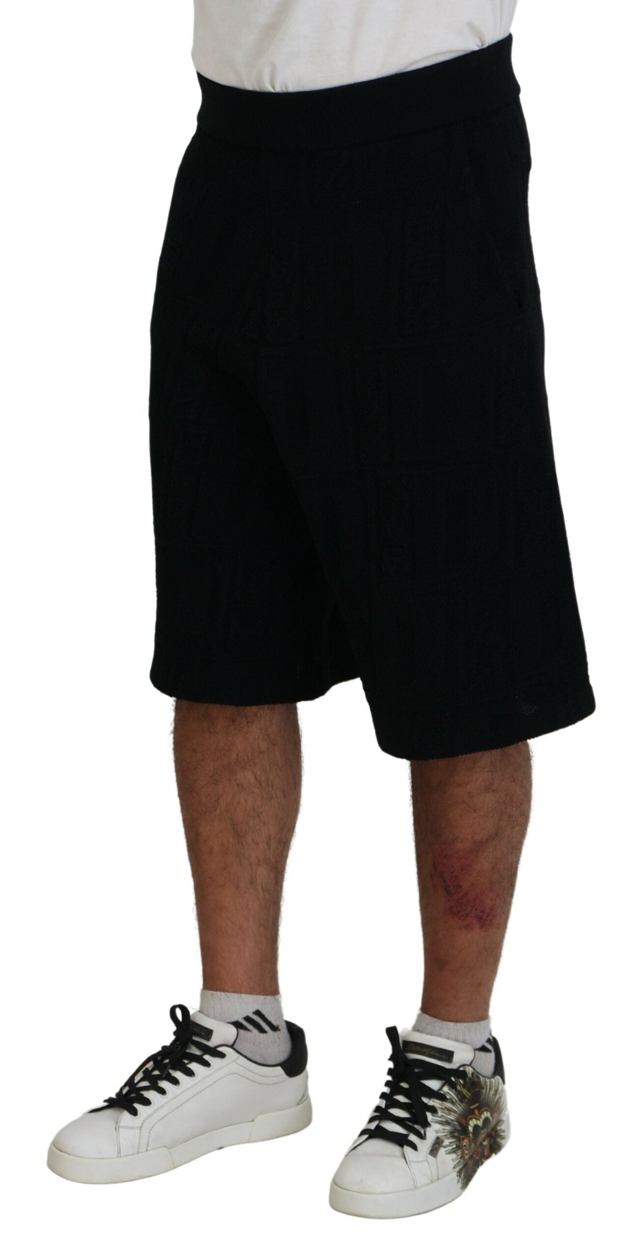 Black shorts on a man wearing sneakers