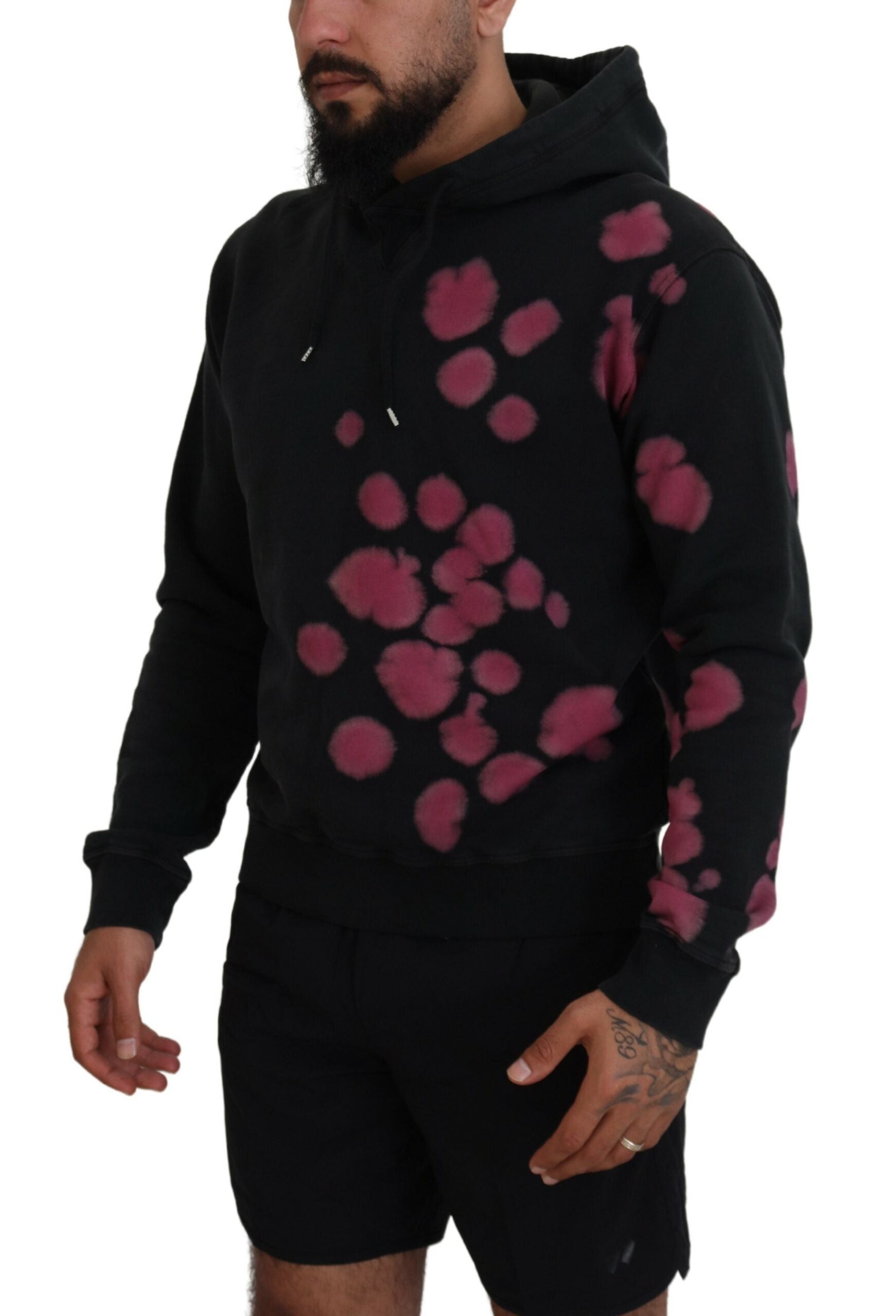 Man wearing black hoodie with pink spots