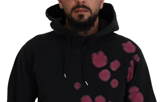 Man wearing black hoodie with pink spots