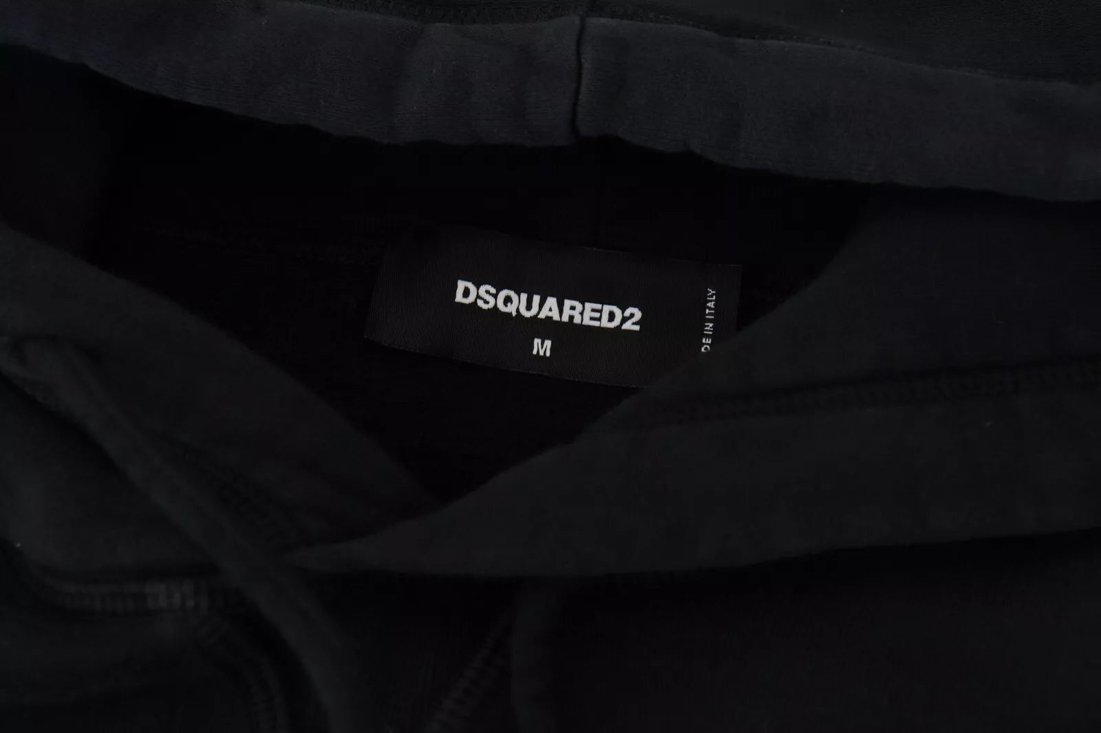 Black clothing tags on clothes