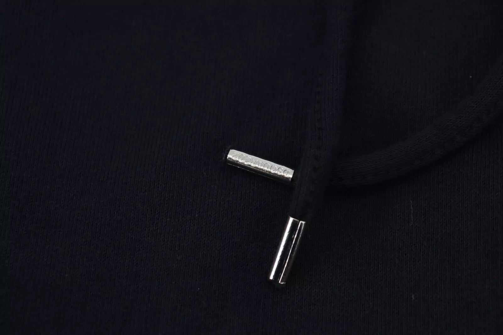Silver zipper pull on black fabric