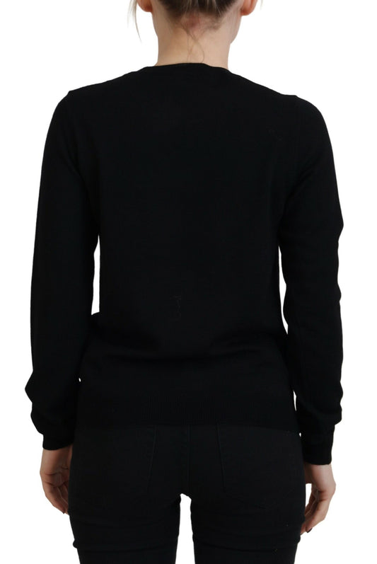 Black long sleeve sweater worn by a person from behind