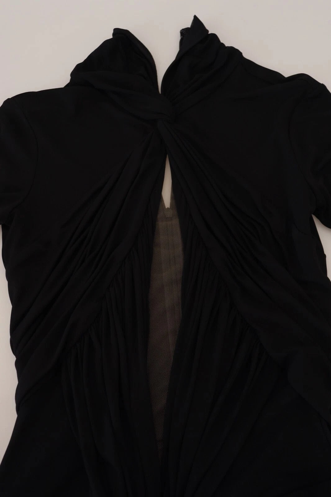 A black viscose long sleeve dress with cutouts and a sheer overlay
