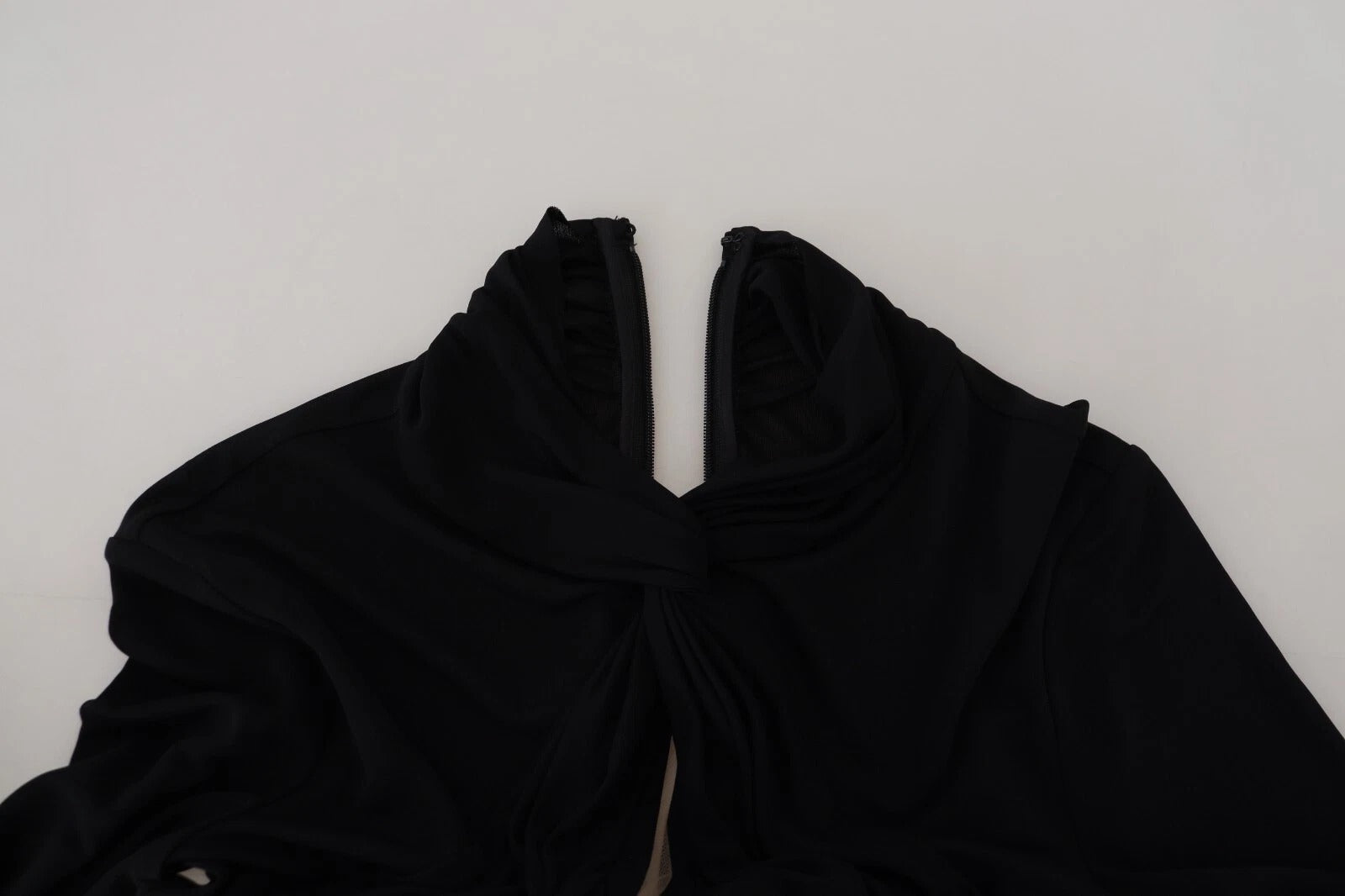 A black viscose long sleeve cut out mini dress with a high neckline