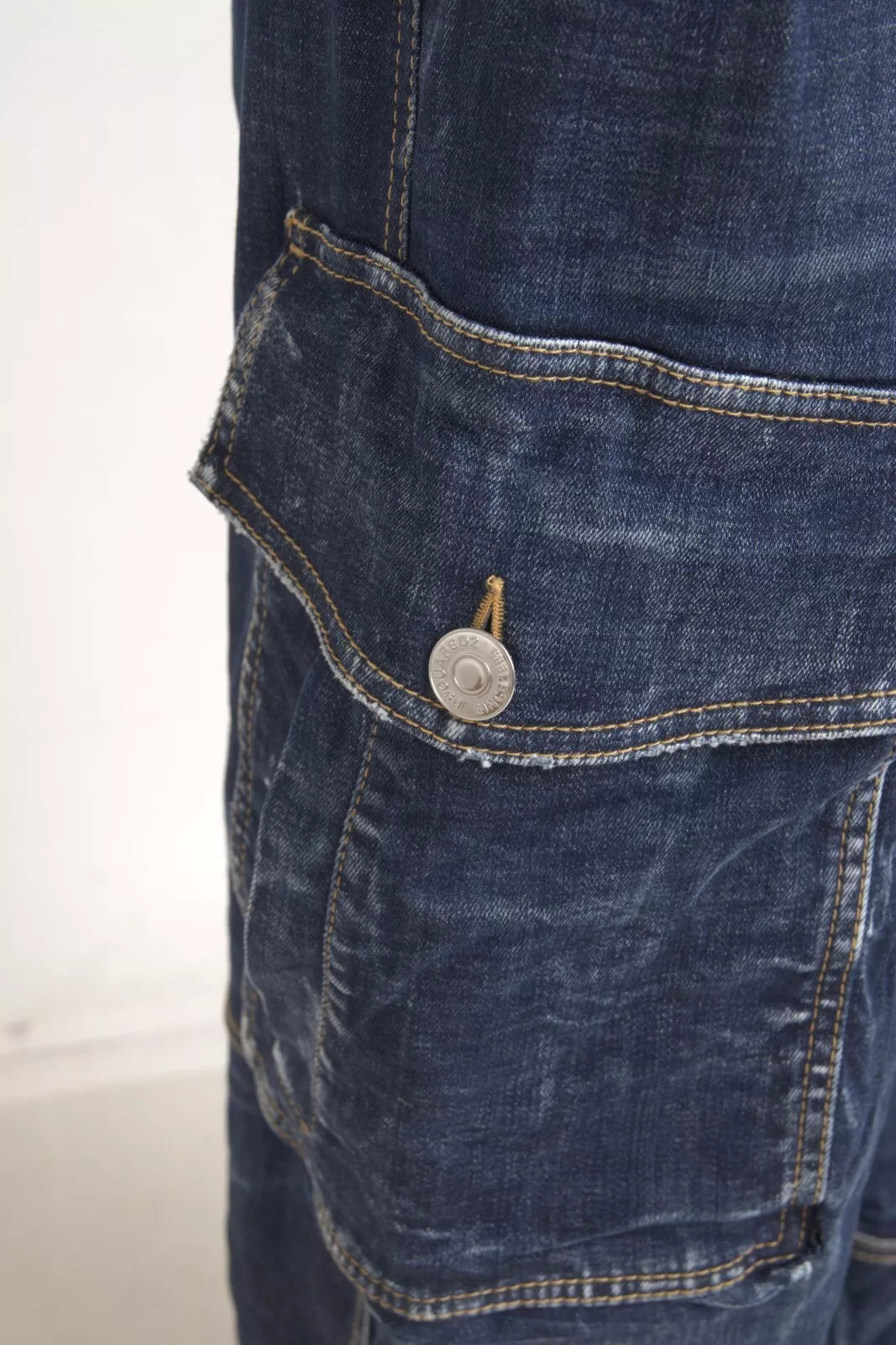 Pocket on blue jeans with button closure