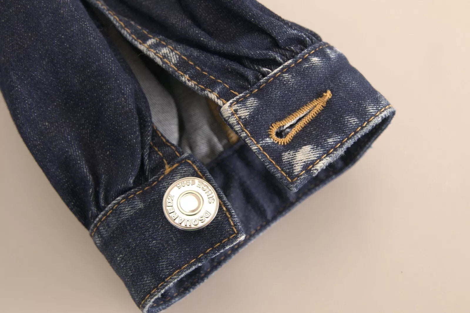 Blue denim jacket with buttoned cuffs and a pocket on the left chest