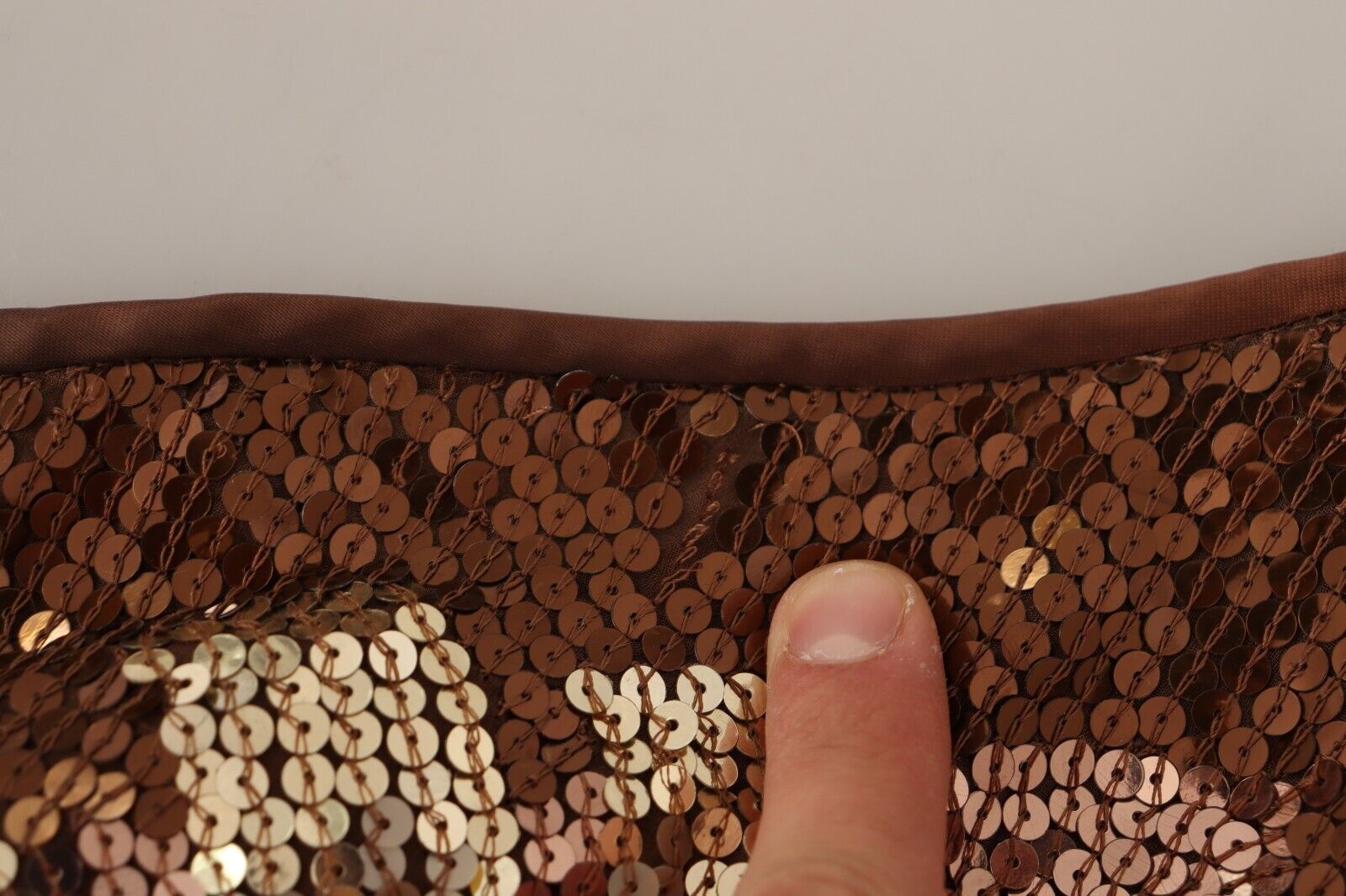 A brown sequined dress with a leaf pattern on one shoulder, featuring a shift style and long length