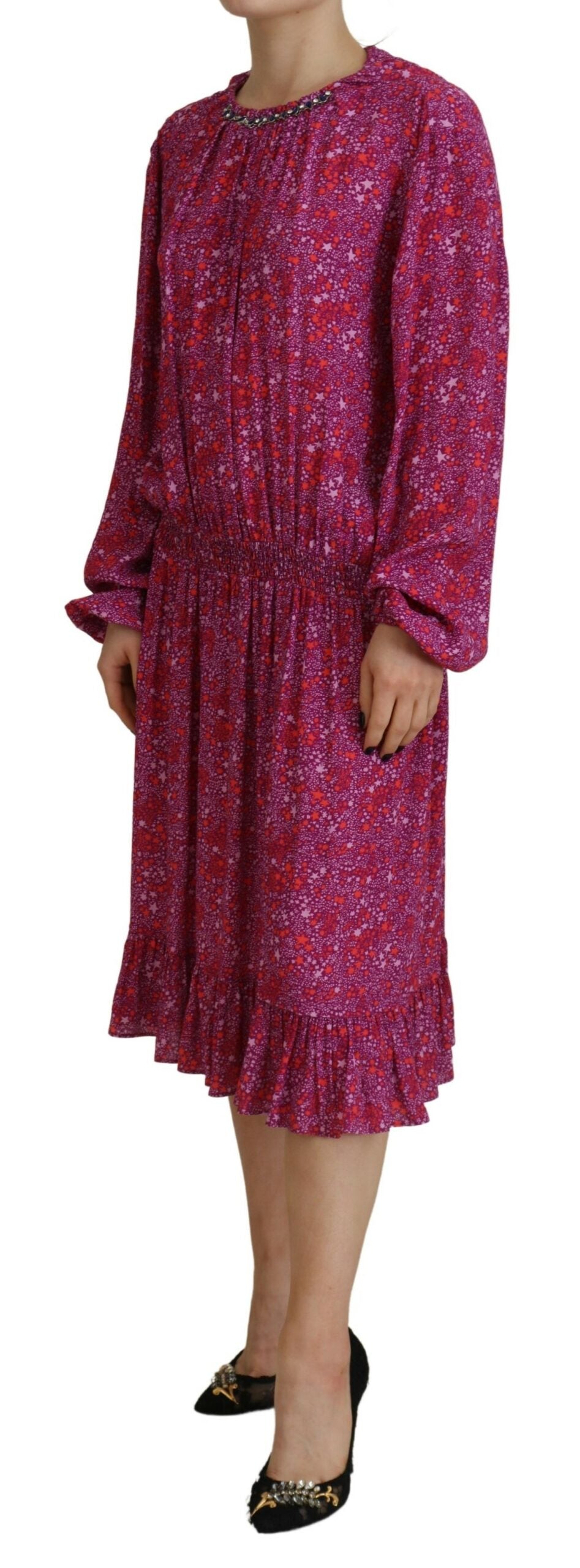 A long sleeve dress with a fuchsia floral pattern and embellishments