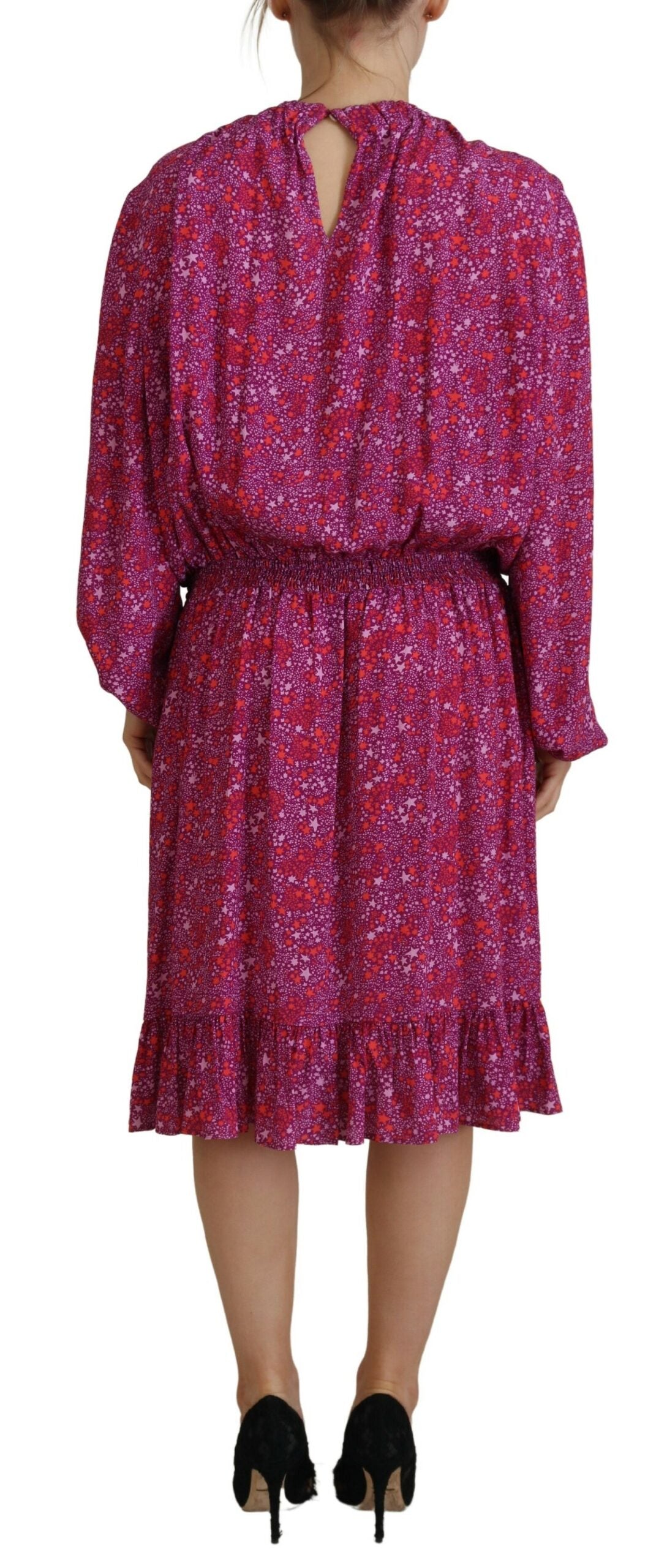A long sleeve dress with a fuchsia floral pattern and embellishments