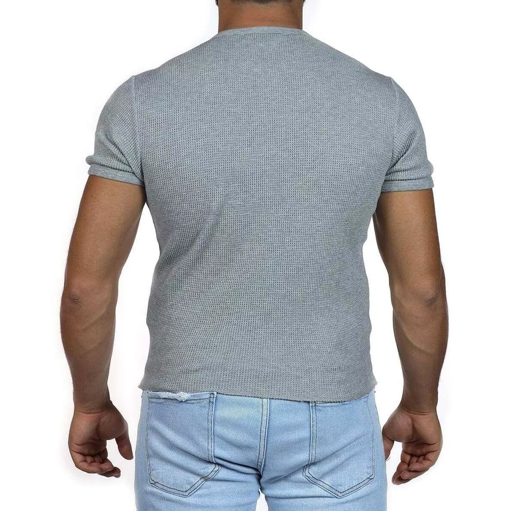 Man wearing gray sweater and blue jeans