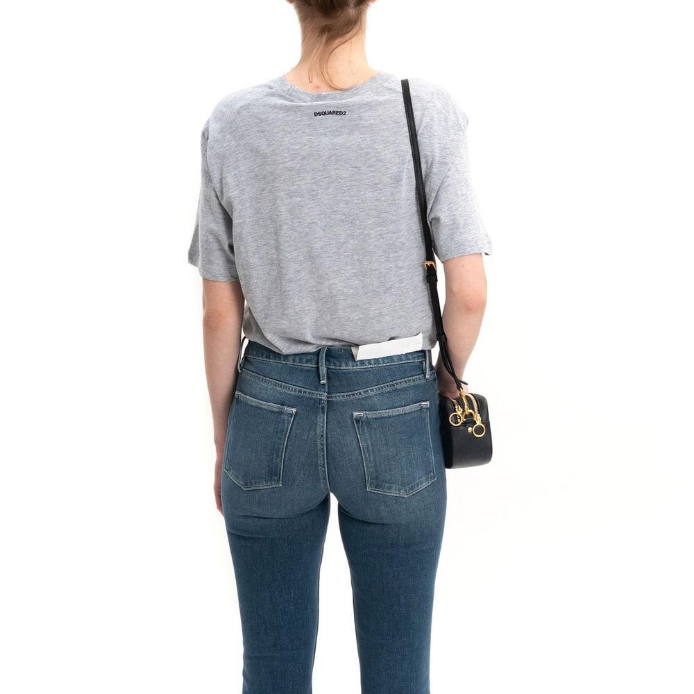 Woman wearing blue jeans and grey shirt