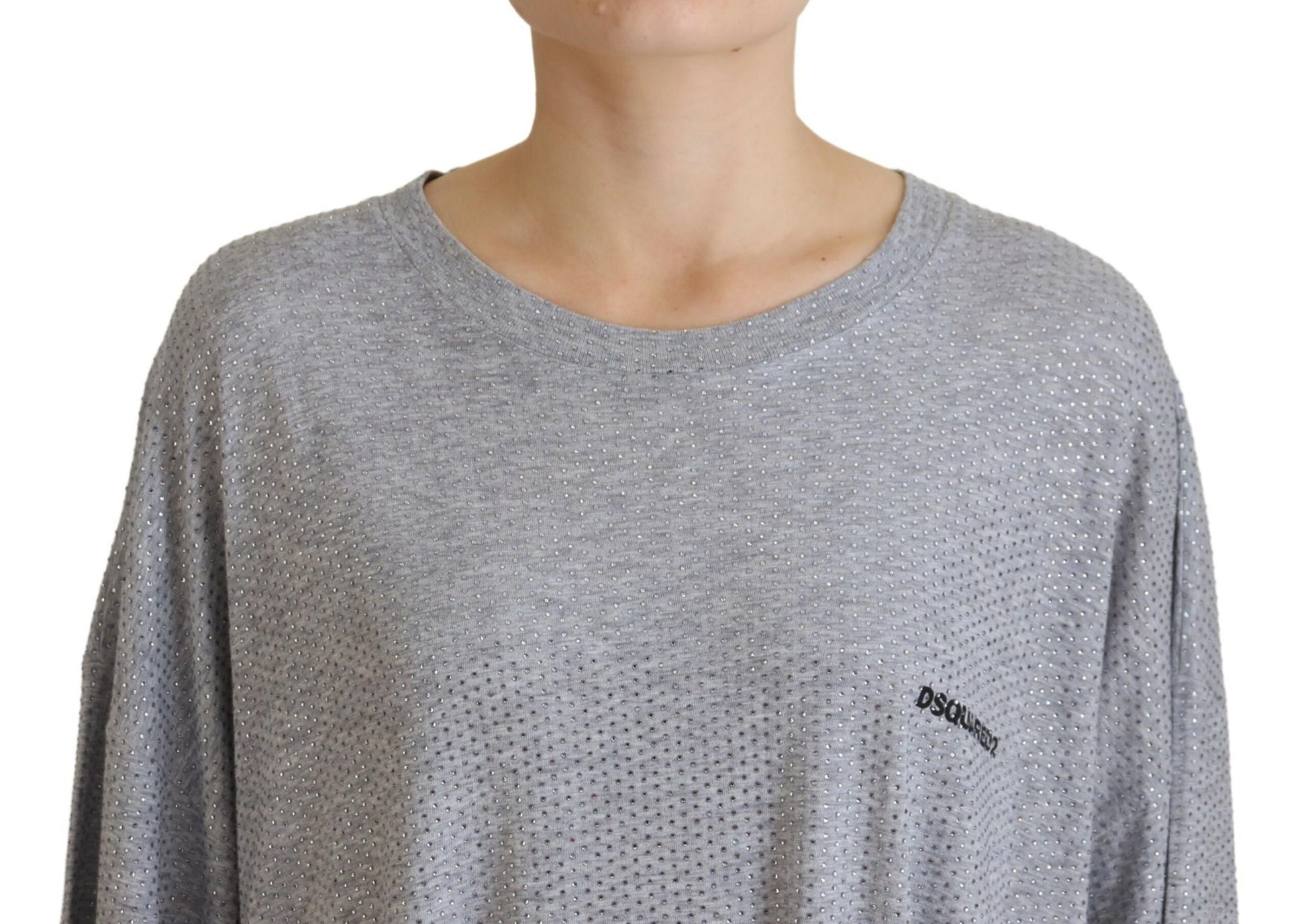 A gray long sleeve dress with crystal embellishments on the front