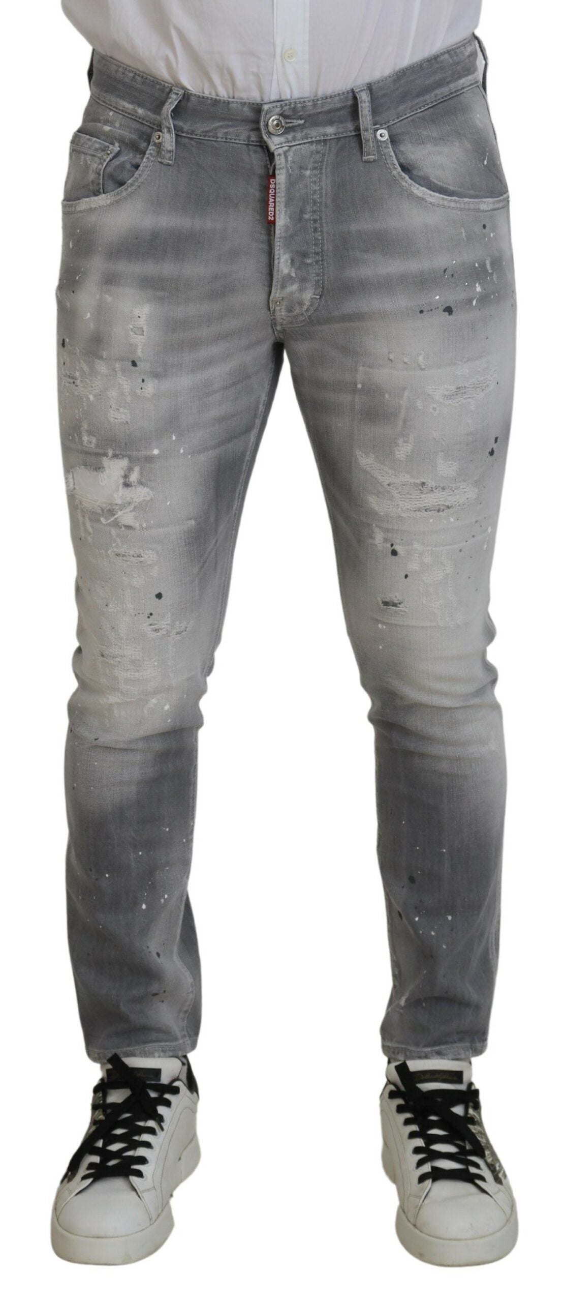 Pair of distressed jeans worn by a person