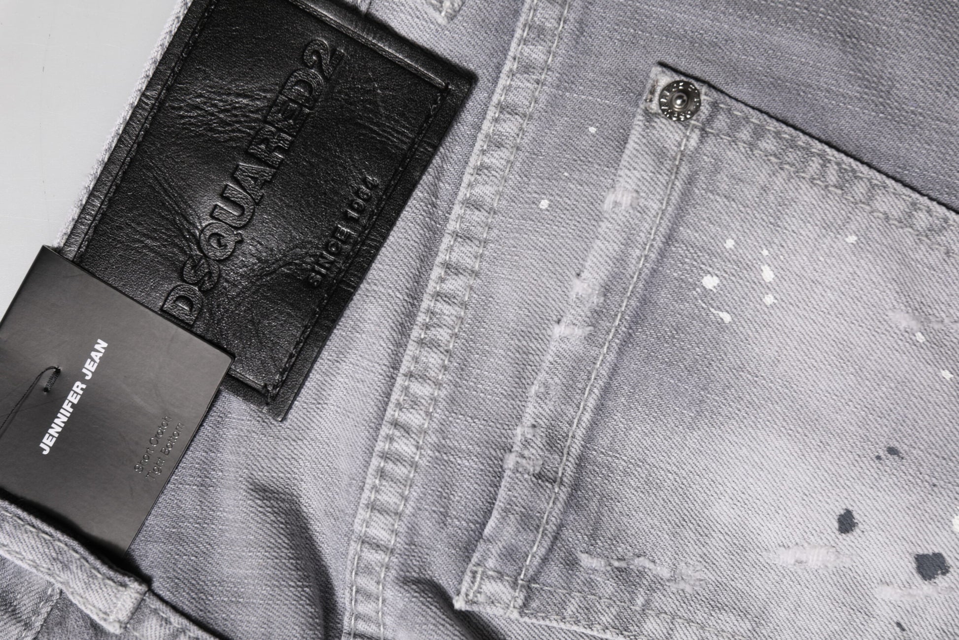 Pair of blue jeans with black leather patches on front