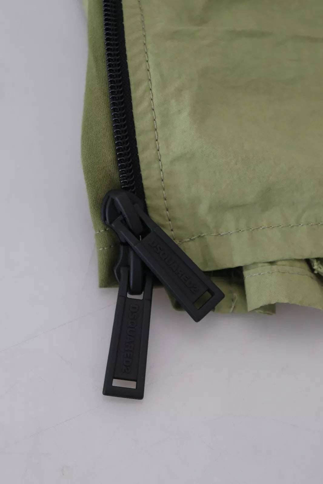 A green cotton mid waist drawstring tapered shorts with a black zipper