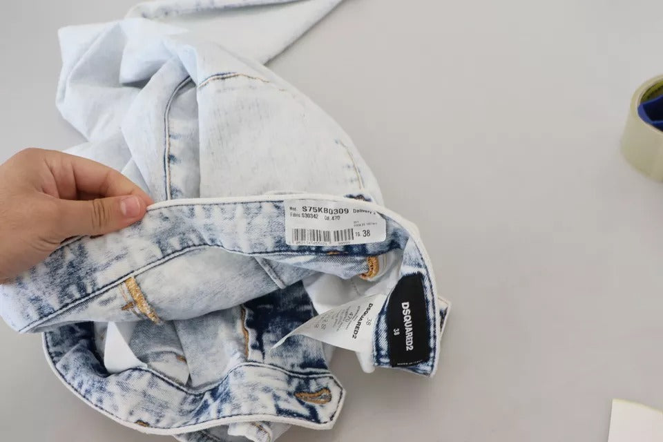 Person holding blue jeans on table