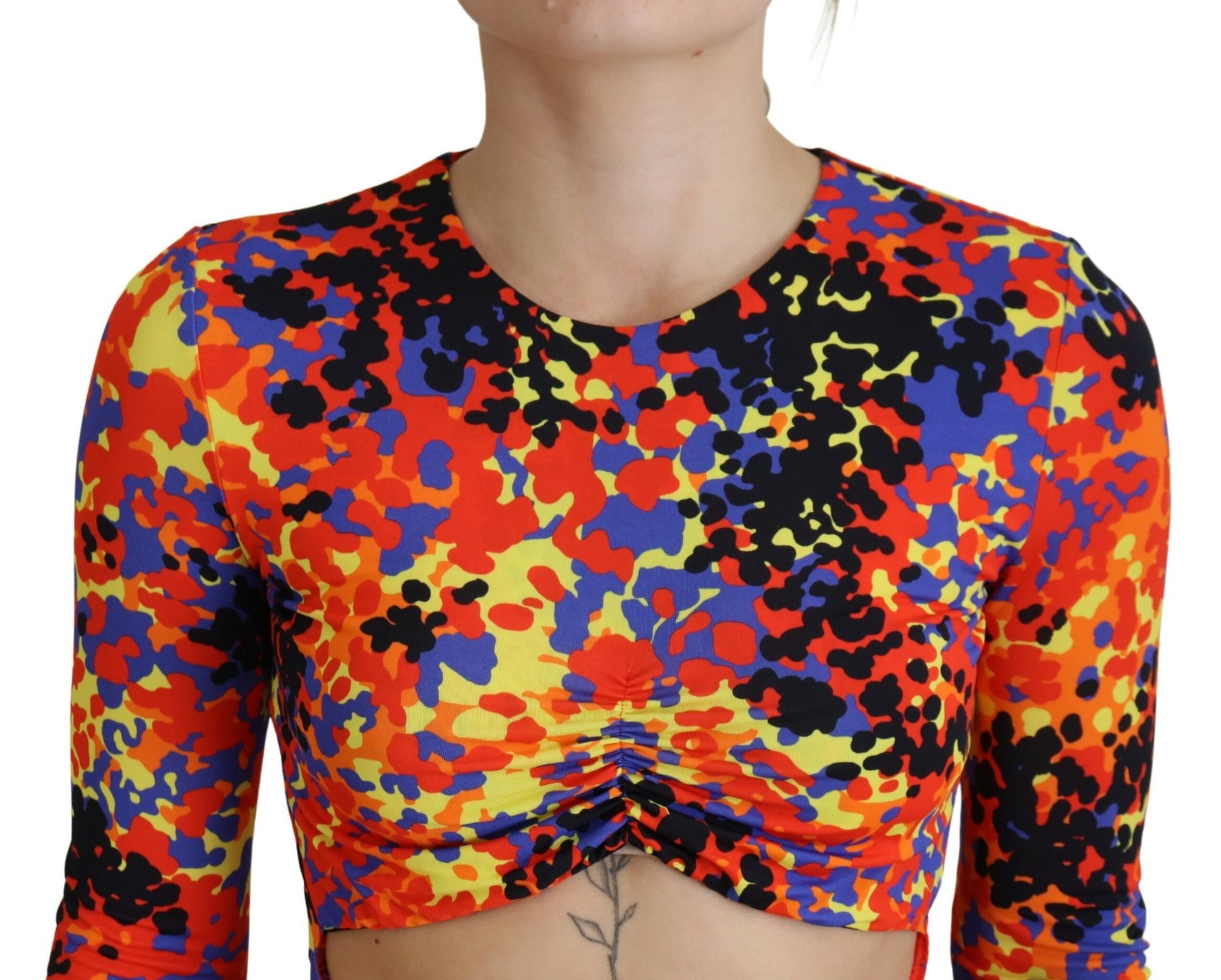 A colorful, batik-style dress with long sleeves and an open belly design