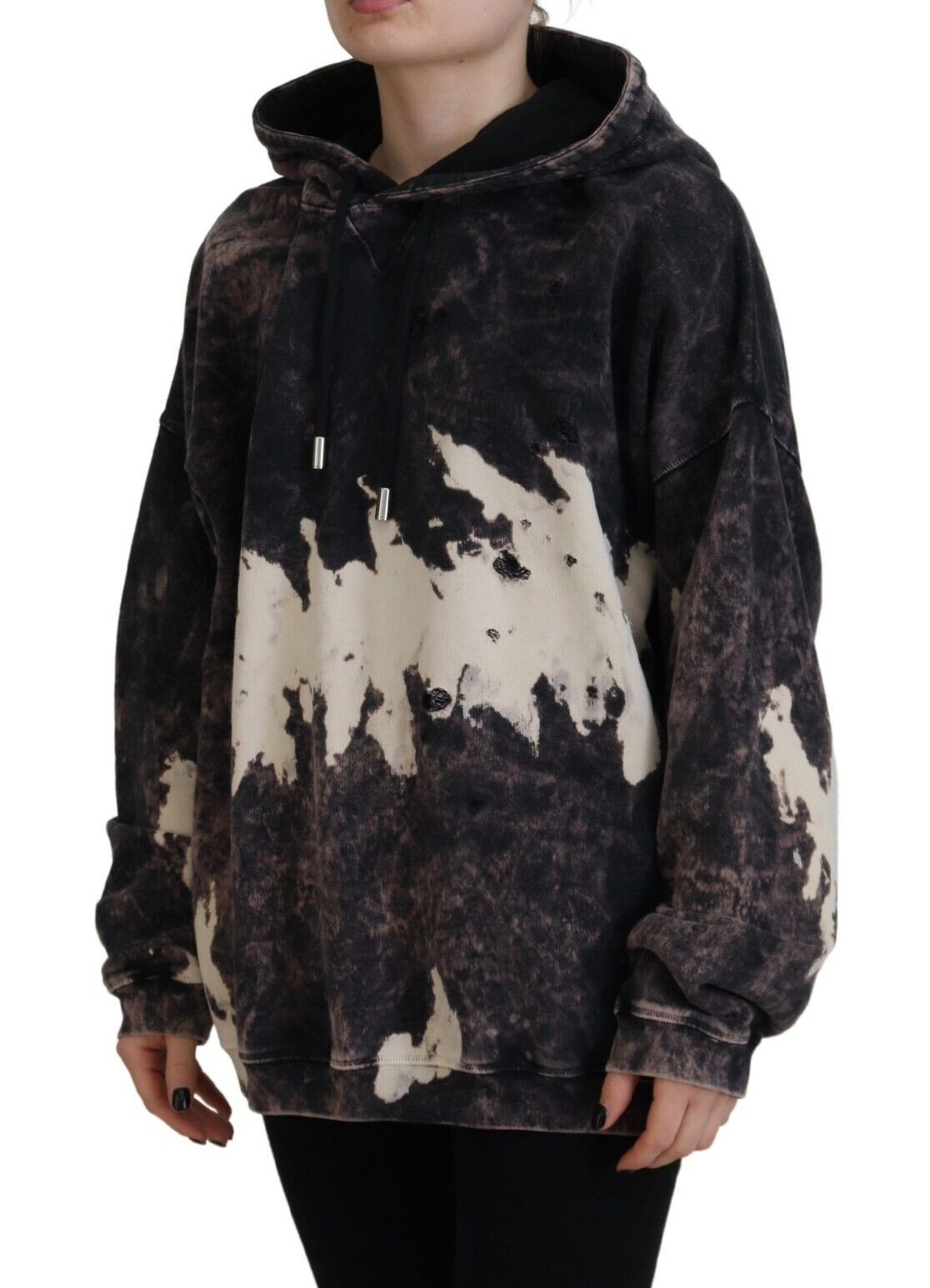 Woman wearing oversized hoodie with distressed design