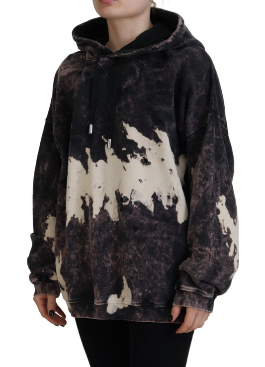 Woman wearing oversized hoodie with distressed design