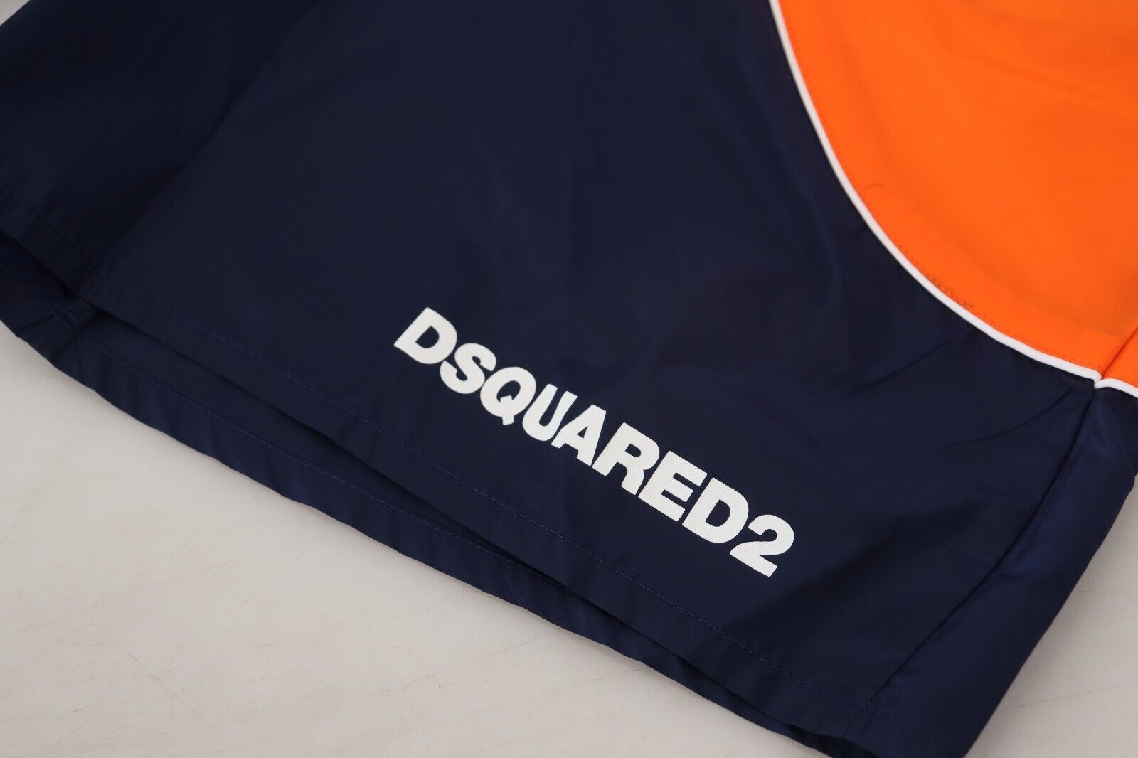 Blue jacket with orange trim and white lettering