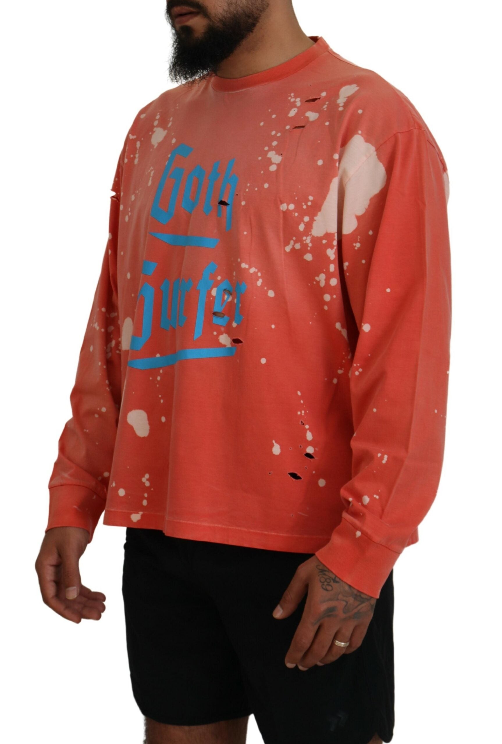 Man wearing orange long sleeve shirt with blue writing