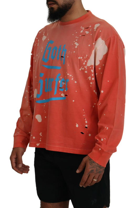 Man wearing orange long sleeve shirt with blue writing