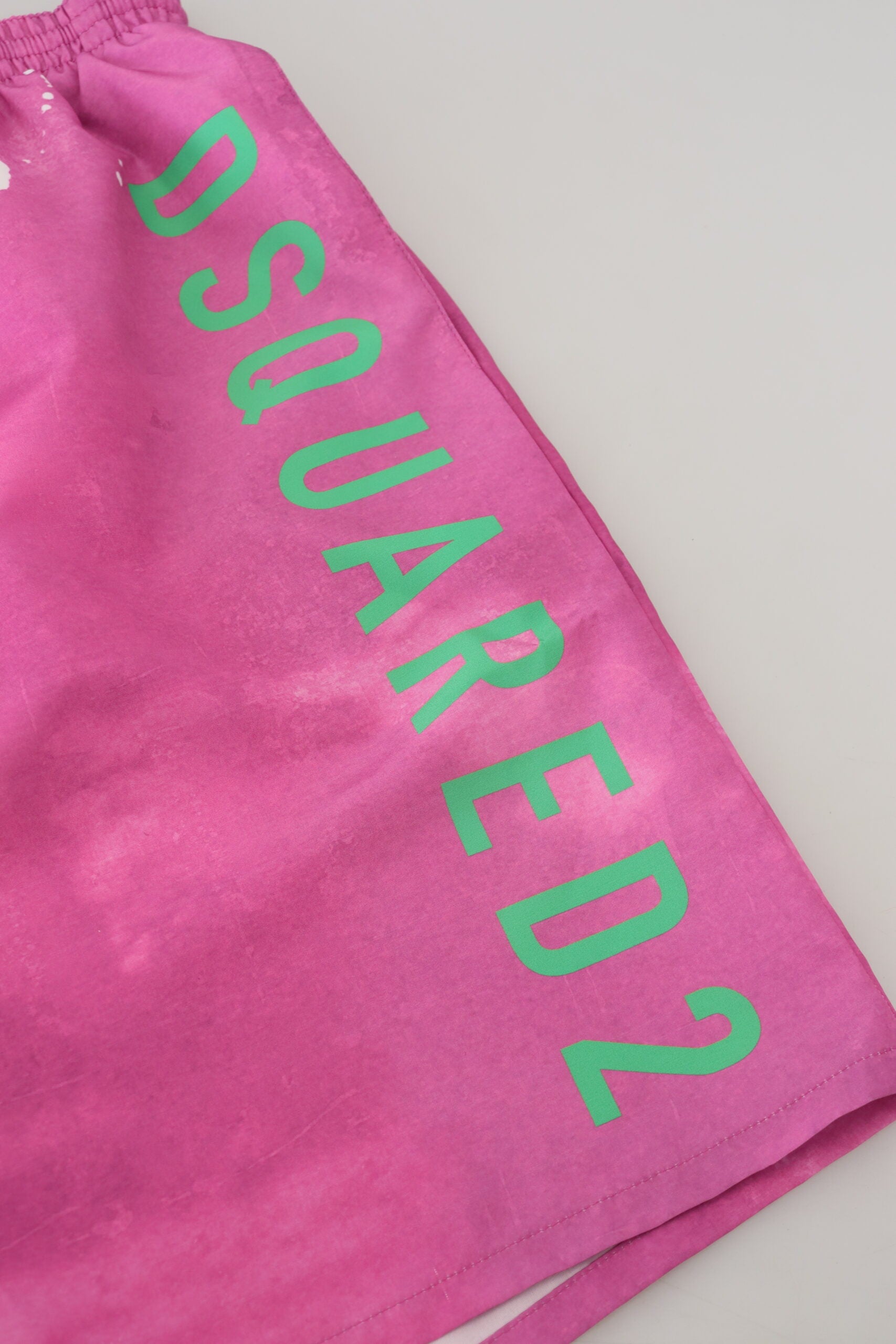 Pink shorts with green lettering
