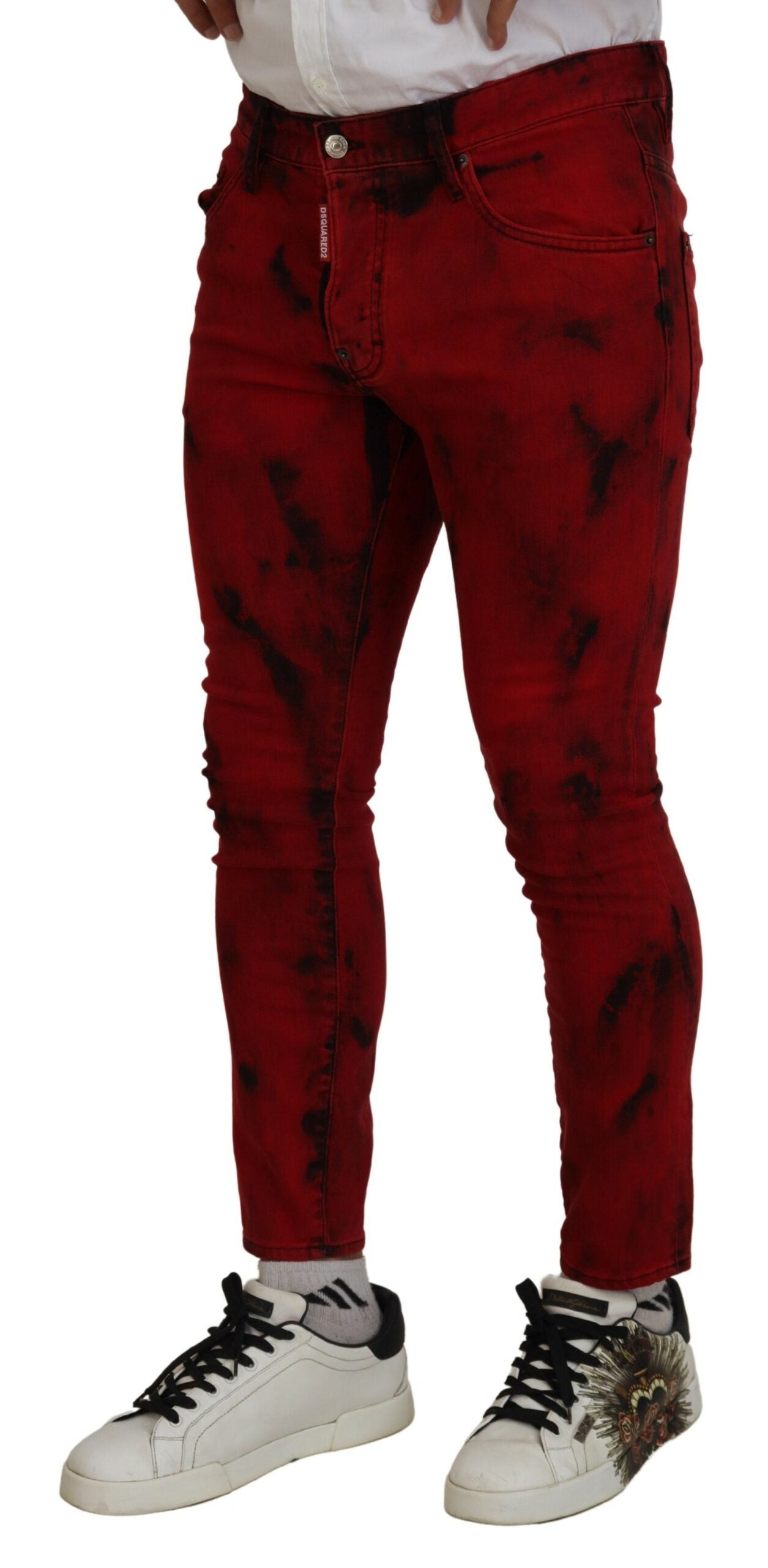 Red distressed jeans with black laces on sneakers